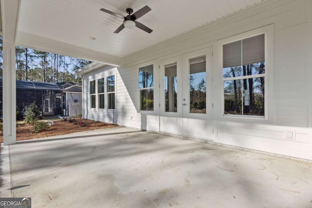 unfurnished sunroom featuring a healthy amount of sunlight and a ceiling fan