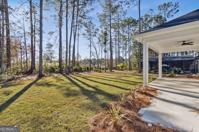 view of yard featuring a ceiling fan and a patio