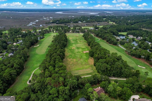 birds eye view of property with a water view and golf course view