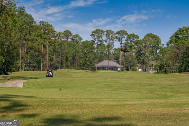 view of home's community featuring a lawn and golf course view