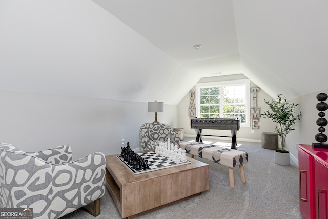 sitting room featuring lofted ceiling, carpet, and baseboards