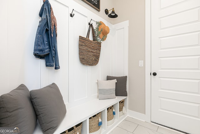 mudroom with marble finish floor and baseboards