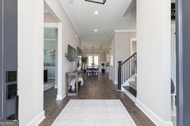 entrance foyer with recessed lighting, dark wood-type flooring, baseboards, stairs, and ornamental molding