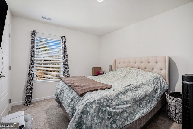 bedroom featuring baseboards, visible vents, and carpet flooring