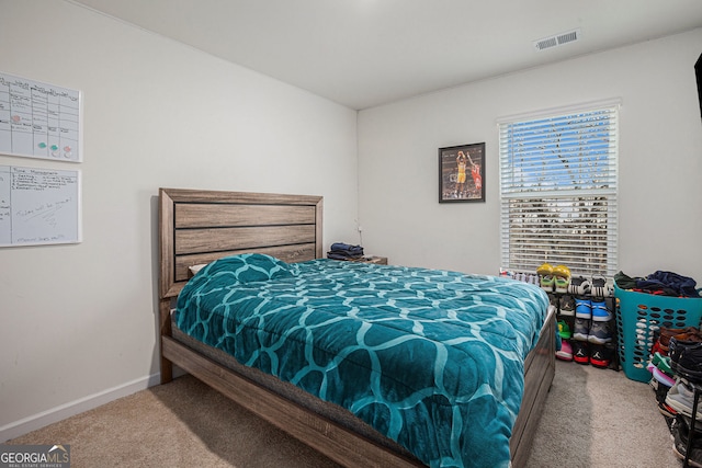 carpeted bedroom featuring visible vents and baseboards