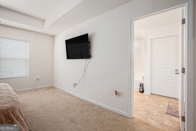 unfurnished bedroom with light colored carpet and baseboards