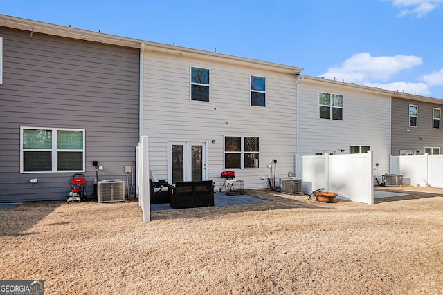 rear view of property featuring central AC, a patio area, and fence