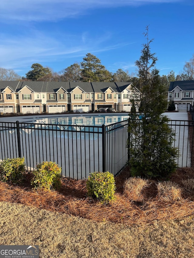 pool featuring a residential view and fence