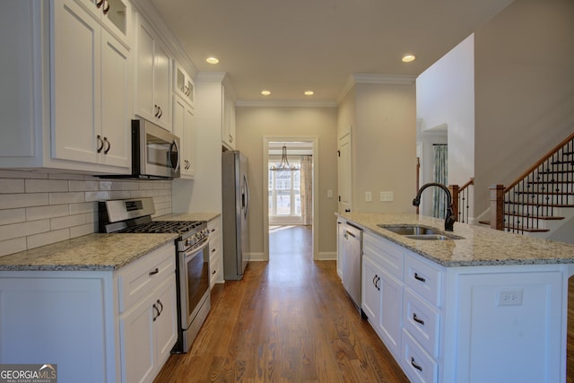 kitchen featuring light stone counters, stainless steel appliances, glass insert cabinets, white cabinets, and a sink