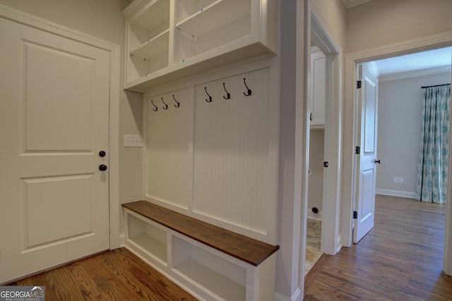 mudroom with baseboards and wood finished floors