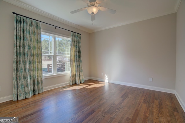 unfurnished room with dark wood-style floors, crown molding, baseboards, and ceiling fan