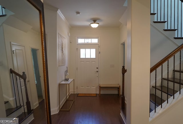 doorway to outside with stairs, ornamental molding, dark wood finished floors, and baseboards