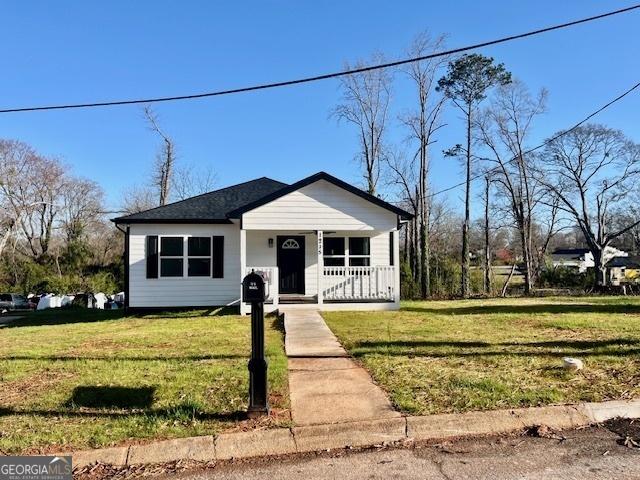 bungalow-style house featuring a porch and a front yard