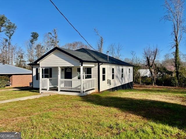 bungalow-style house with a porch and a front lawn