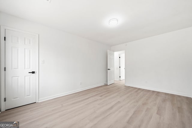 unfurnished room featuring light wood-style floors and baseboards