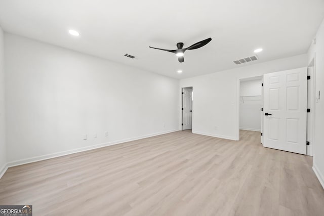 unfurnished bedroom with light wood-style flooring, visible vents, and baseboards