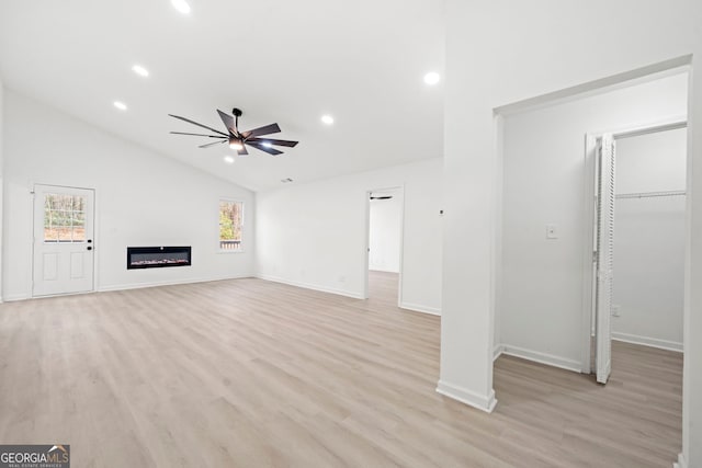 unfurnished living room featuring lofted ceiling, recessed lighting, a glass covered fireplace, ceiling fan, and light wood-type flooring