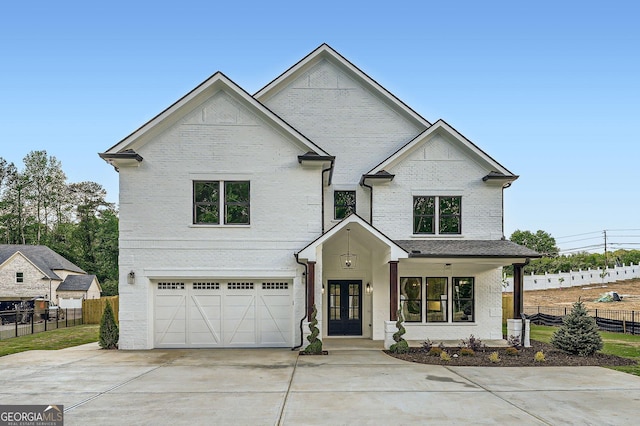 1523 Grayson Pkwy, Grayson, GA 30017 - view of front facade featuring concrete driveway, a garage, brick siding, and french doors