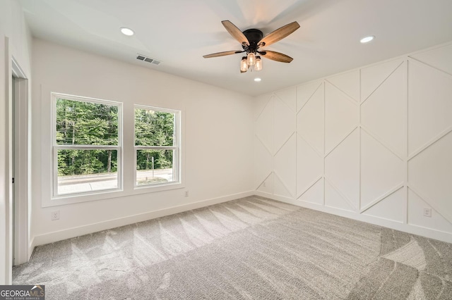 bedroom featuring recessed lighting, a glass covered fireplace, a ceiling fan, light wood finished floors, and a raised ceiling