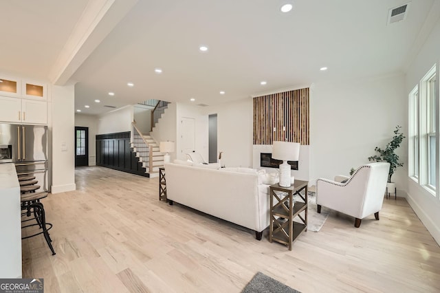 dining area with plenty of natural light, light wood-style flooring, and a decorative wall