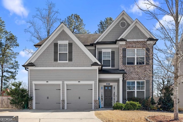 craftsman-style house featuring brick siding, driveway, and an attached garage