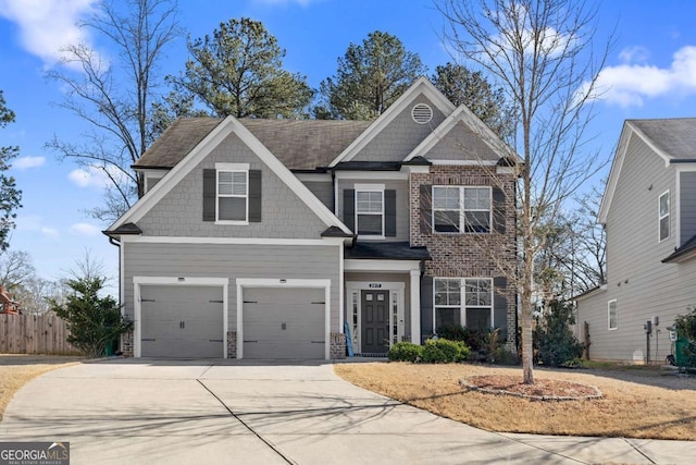 craftsman-style home with driveway and fence