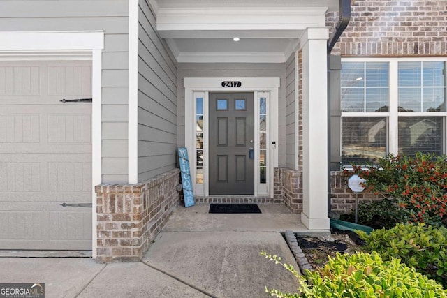 doorway to property with brick siding