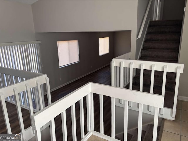 stairs featuring baseboards and tile patterned floors