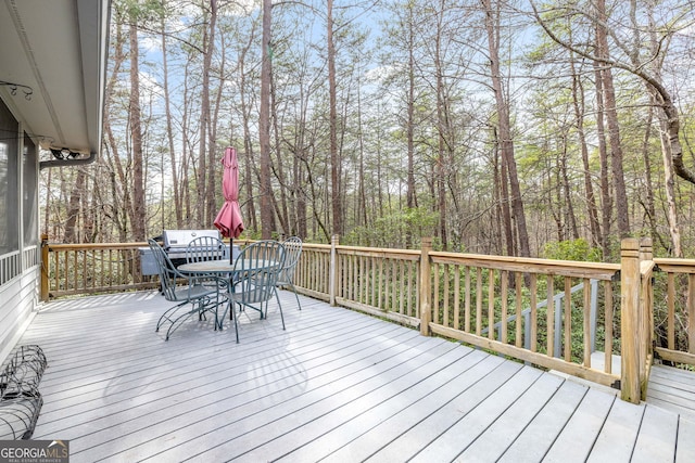 wooden deck featuring outdoor dining space