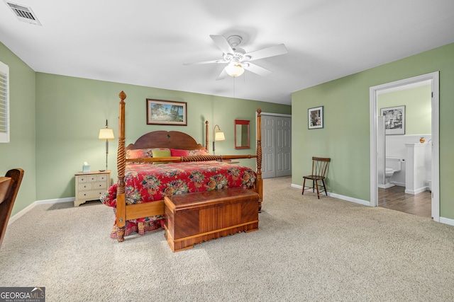 bedroom featuring carpet floors, visible vents, connected bathroom, and baseboards