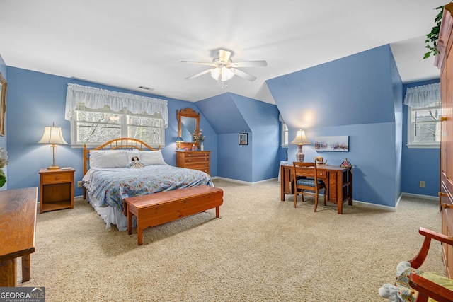 bedroom featuring lofted ceiling, baseboards, multiple windows, and carpet flooring