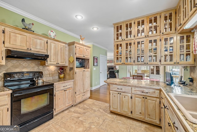 kitchen with tasteful backsplash, glass insert cabinets, ornamental molding, black range with electric stovetop, and under cabinet range hood