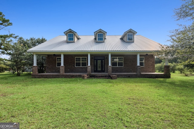 view of front of home with metal roof, a porch, and a front lawn