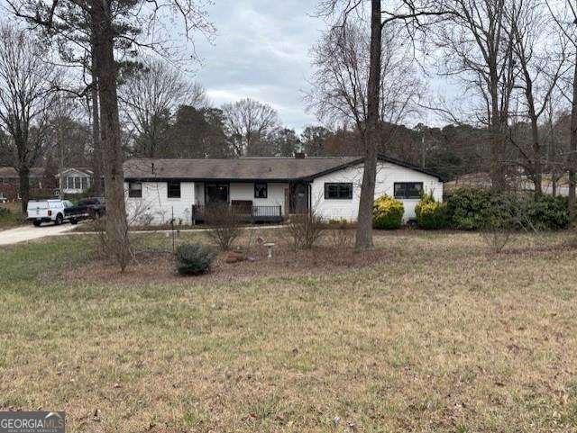 ranch-style home with a front lawn