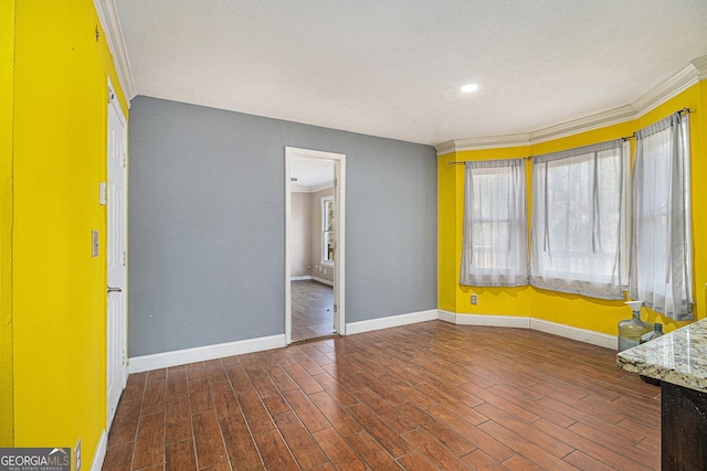 interior space with a wealth of natural light, crown molding, baseboards, and wood finished floors