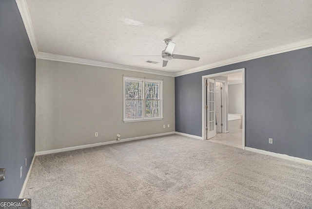 unfurnished bedroom with light colored carpet, visible vents, ornamental molding, a textured ceiling, and baseboards