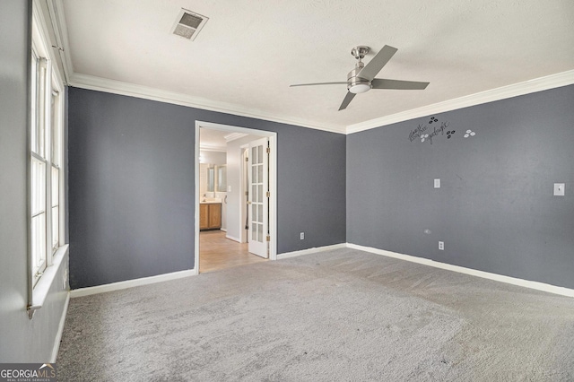 empty room featuring carpet, visible vents, and baseboards