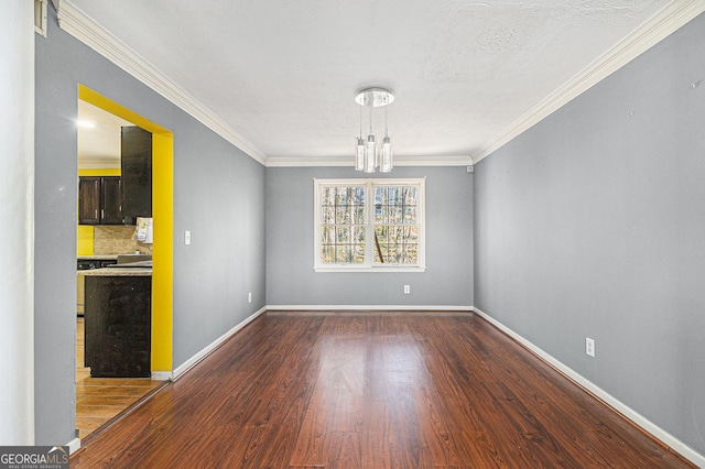 unfurnished dining area with dark wood-style floors, a notable chandelier, crown molding, and baseboards