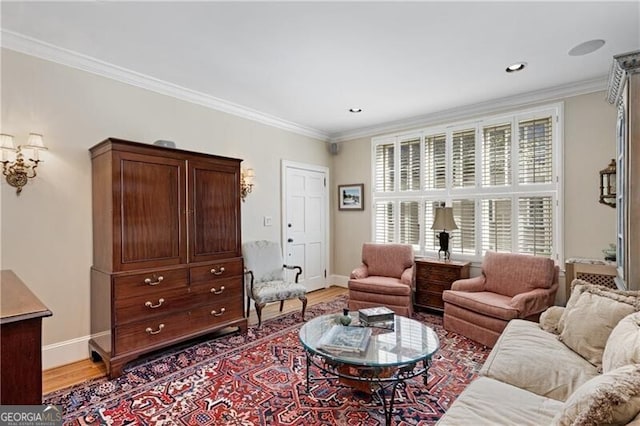living area with light wood-style floors, baseboards, and ornamental molding