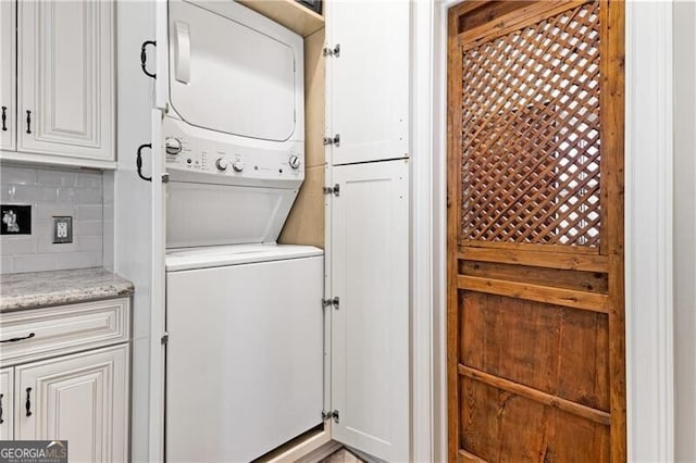 laundry room featuring laundry area and stacked washer / dryer