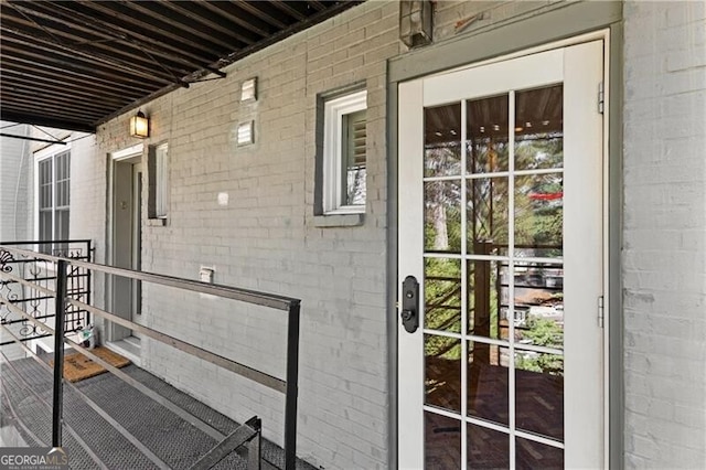 doorway to property with brick siding