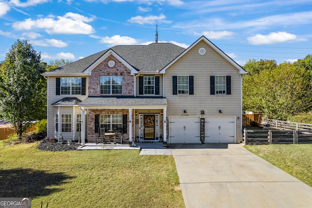 traditional-style home featuring a porch, an attached garage, fence, driveway, and a front lawn