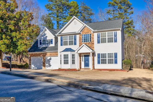 view of front of house with a garage, stone siding, driveway, and roof with shingles