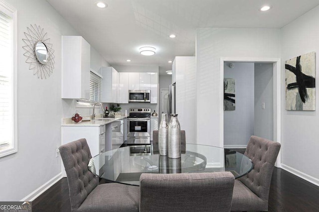 dining area featuring baseboards, dark wood-style flooring, and recessed lighting