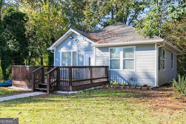 view of front of house with a front lawn and a deck