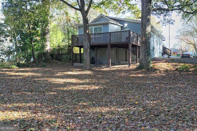 back of property with a wooden deck