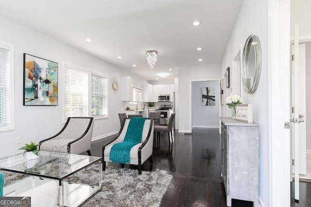 sitting room with recessed lighting, dark wood-style flooring, and baseboards