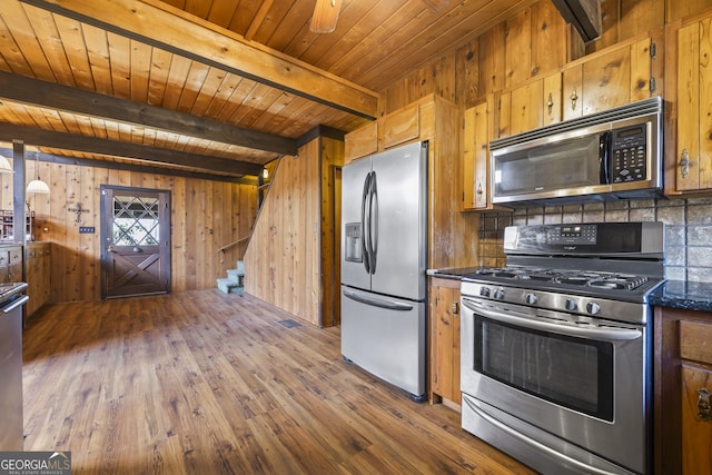 kitchen featuring stainless steel appliances, wood finished floors, beam ceiling, tasteful backsplash, and brown cabinetry