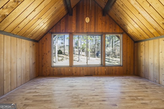 bonus room with vaulted ceiling with beams, plenty of natural light, and light wood finished floors