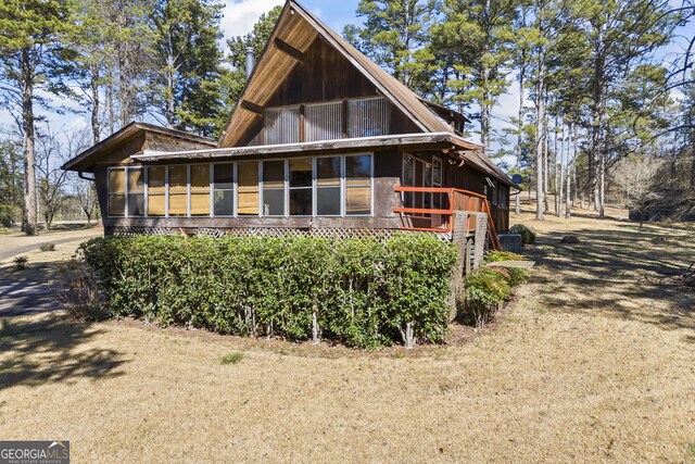 exterior space featuring a front yard and a sunroom